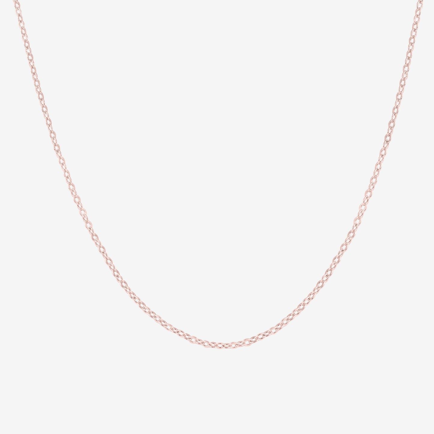 Studio shot of a 18k rose gold cable chain necklace, shown on a neutral grey backdrop