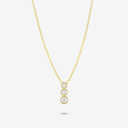 Studio shot of the Gold Aviel Necklace featuring three round bezel-set moissanite stones in a vertical drop, on a light grey background