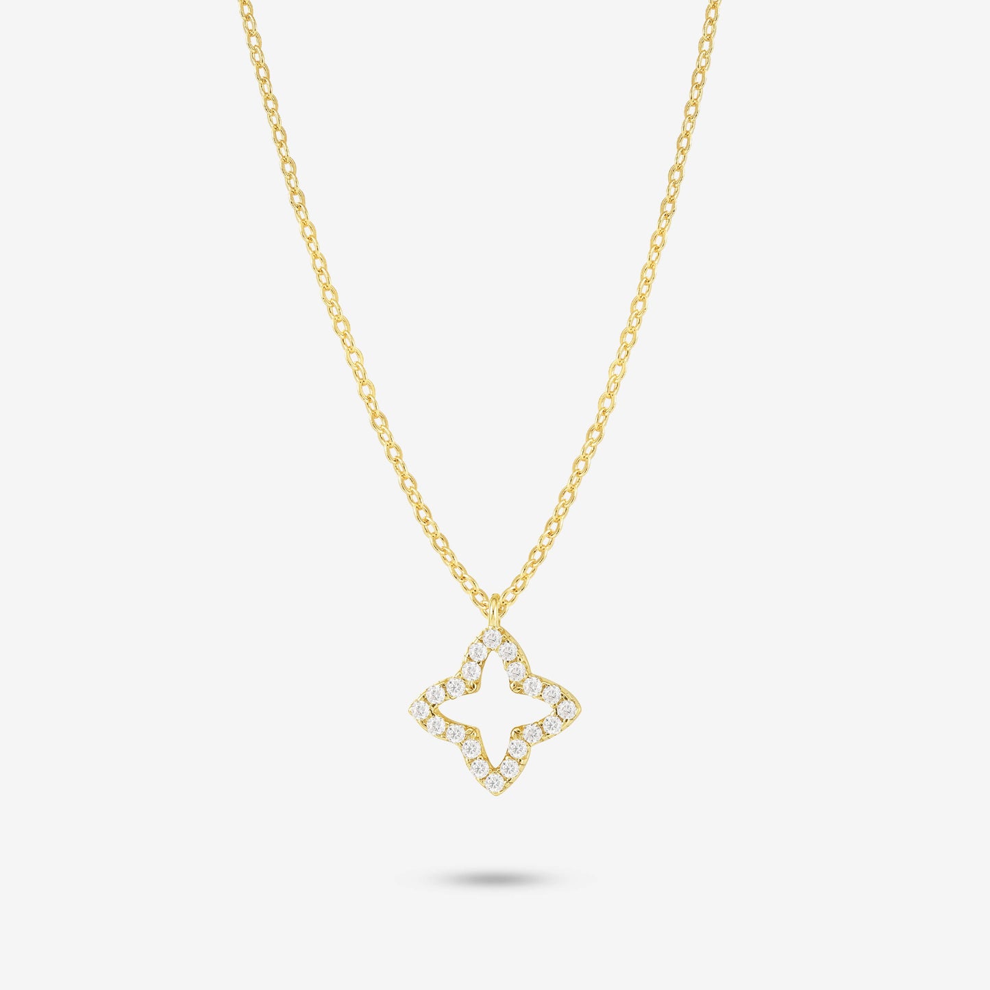 Studio shot of the Gold Eden Necklace showcasing an openwork flower-shaped pendant set with moissanites on a yellow gold chain, presented on a neutral grey background