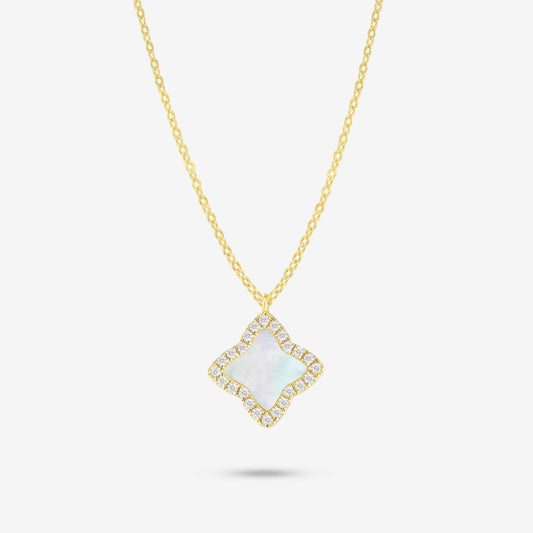 Studio shot of the Gold Edea Necklace with a clover-shaped pendant framed by moissanites and iridescent mother-of-pearl, photographed on a plain grey backdrop