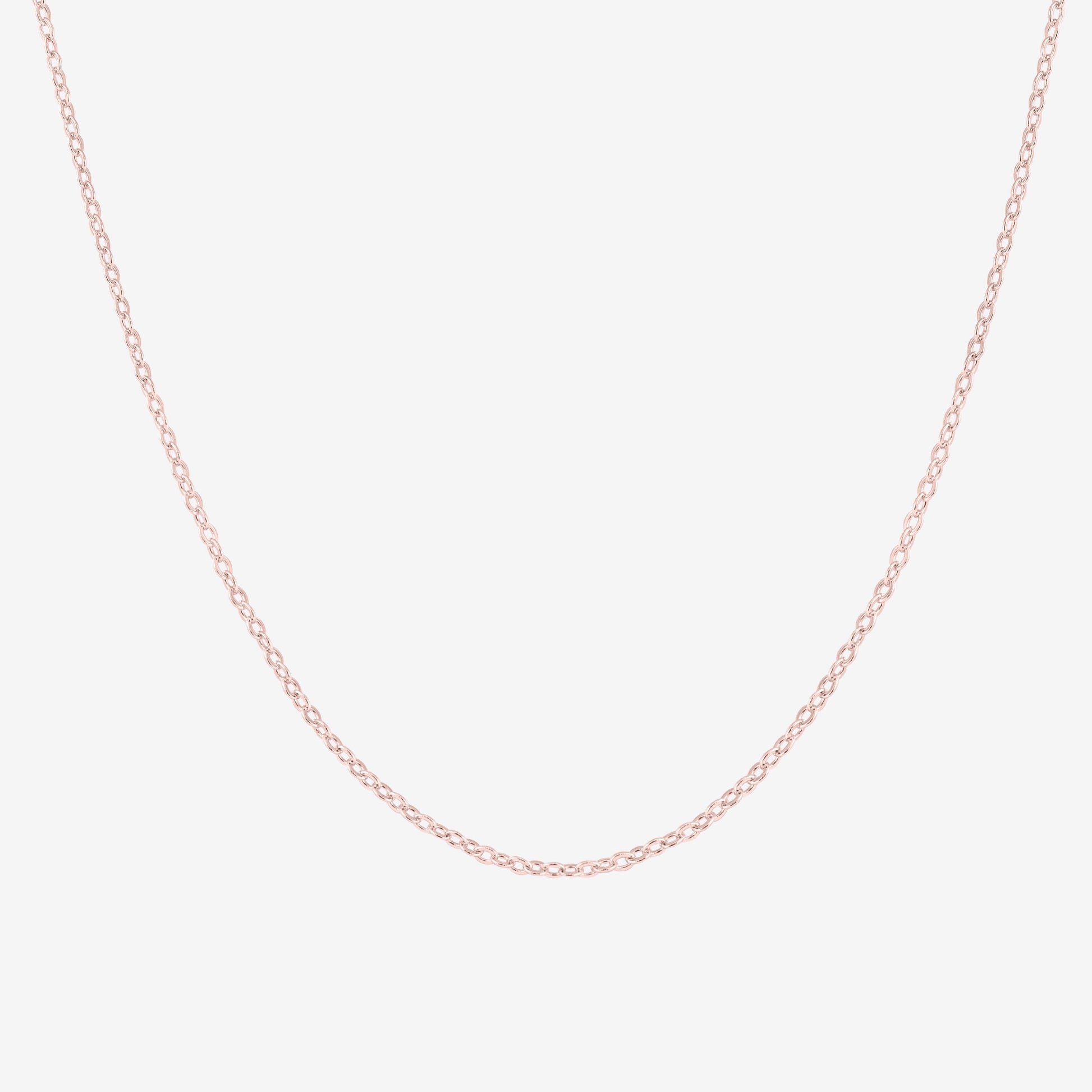 Studio shot of a 18k rose gold cable chain necklace, shown on a neutral grey backdrop