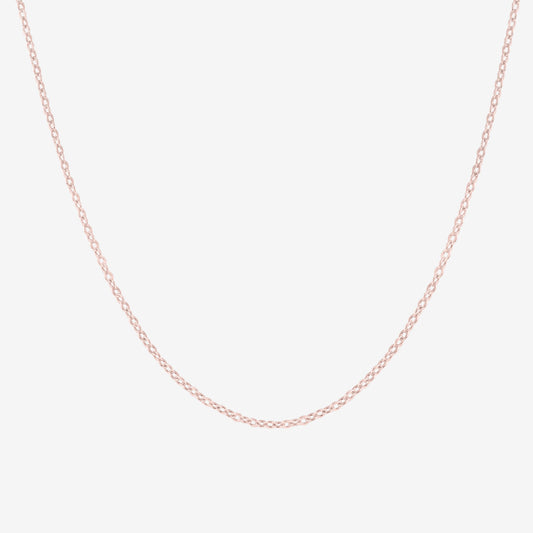 Studio shot of a 18k rose gold cable chain necklace, shown on a neutral grey backdrop