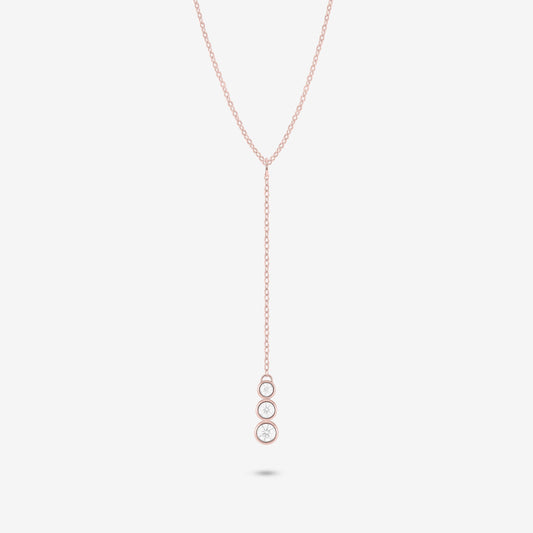 Studio shot of the Rose Gold Astral Necklace with a trio of graduated bezel-set moissanites in a vertical drop pendant design, shown against a neutral grey background