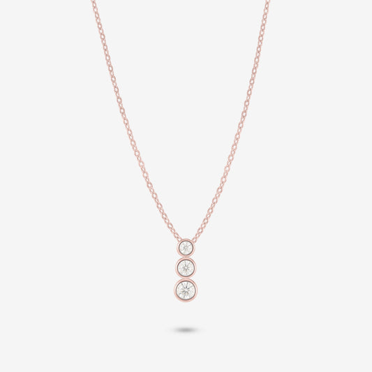 Studio shot of the Rose Gold Aviel Necklace with three graduated bezel-set moissanite stones in a pendant, photographed against a neutral grey backdrop