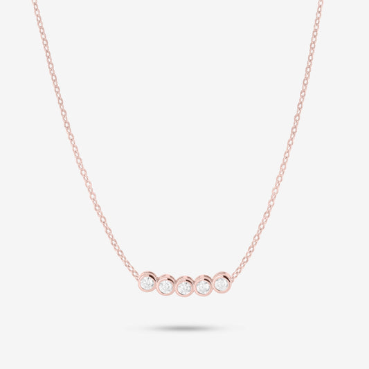 Studio shot of the Rose Gold Dawn Necklace with five bezel-set moissanites in a horizontal row on a fine rose gold chain against a neutral grey backdrop