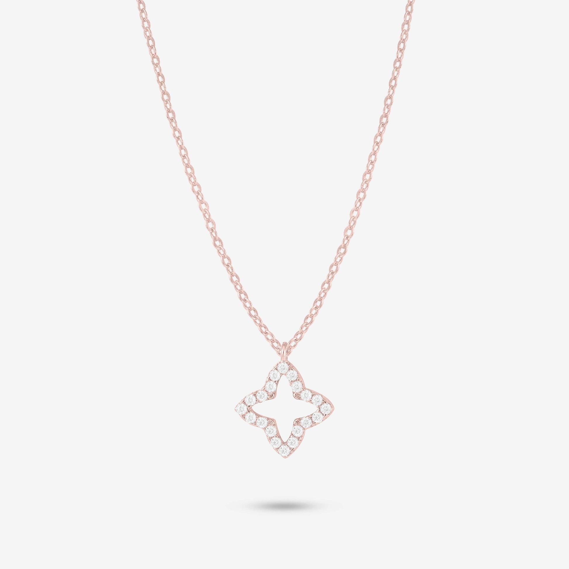 Studio shot of the Rose Gold Eden Necklace featuring a four-petal floral pendant adorned with moissanites on a delicate rose gold chain against a light grey background