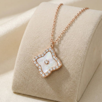 Rose gold mother of pearl halo necklace with sparkling stones on a delicate chain.