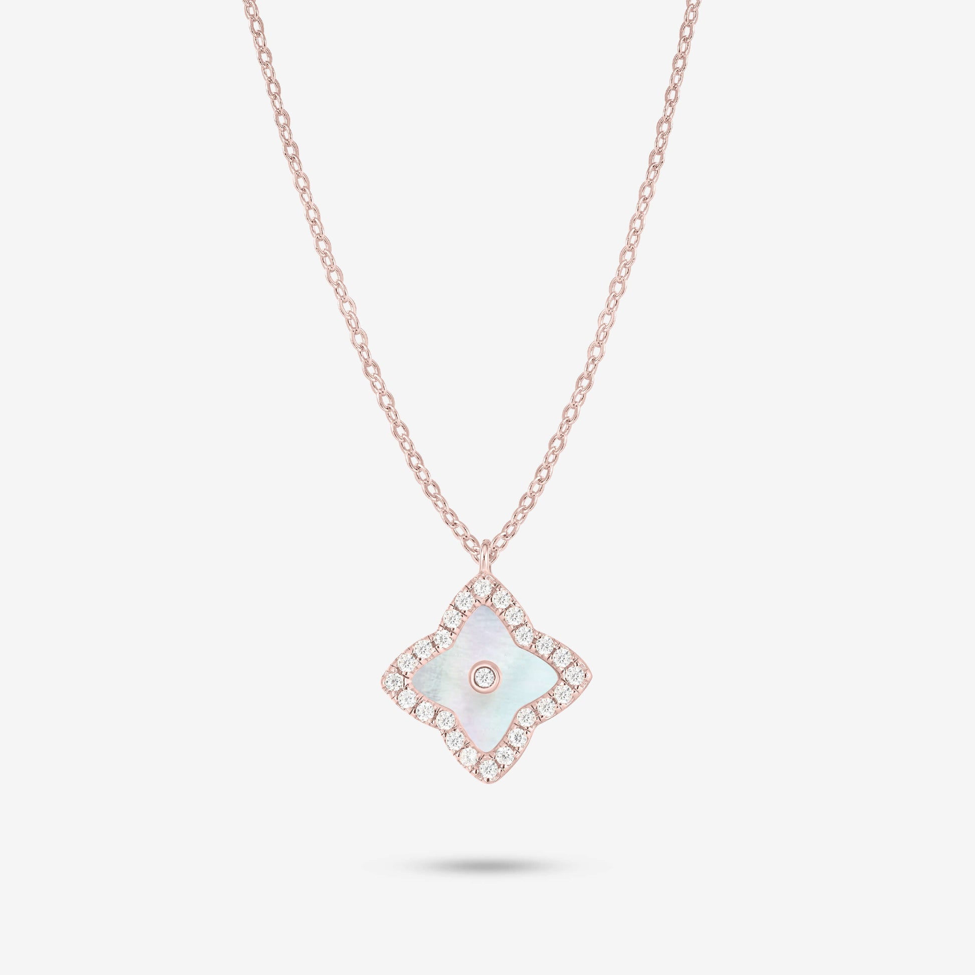 Studio shot of the Rose Gold Irida Necklace styled with a luminous mother-of-pearl quatrefoil pendant, surrounded by a moissanite halo and central stone on a gray background.