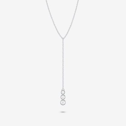 Studio shot of the Silver Astral Necklace featuring a drop pendant with three stacked round bezel-set moissanites against a pale grey backdrop
