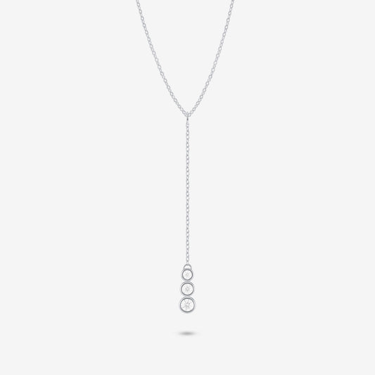 Studio shot of the Silver Astral Necklace featuring a drop pendant with three stacked round bezel-set moissanites against a pale grey backdrop