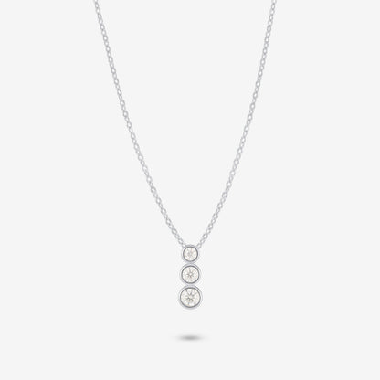 Studio shot of the Silver Aviel Necklace featuring a trio of bezel-set moissanite stones in a vertical arrangement on a pale grey background