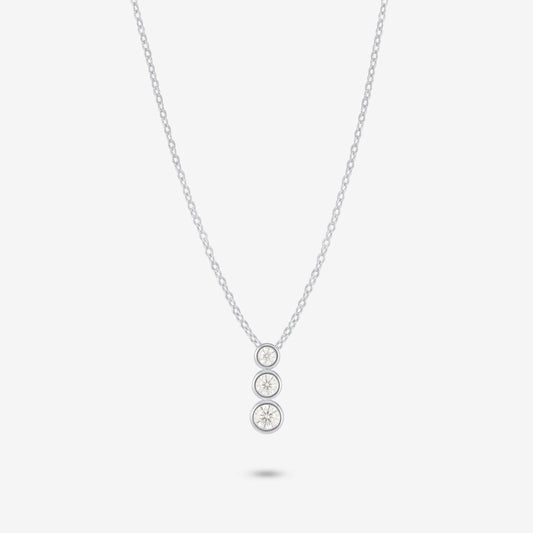 Studio shot of the Silver Aviel Necklace featuring a trio of bezel-set moissanite stones in a vertical arrangement on a pale grey background