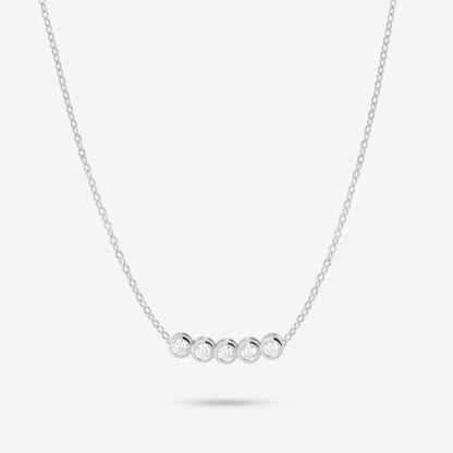 Studio shot of the Silver Dawn Necklace showcasing five bezel-set moissanites in a straight row on a slender silver chain, presented on a pale grey background