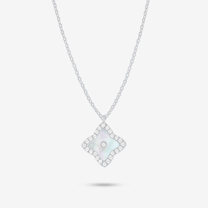 Studio shot of the Silver Irida Necklace with a quatrefoil mother-of-pearl pendant, moissanite halo, and bezel-set center stone on a grey background.
