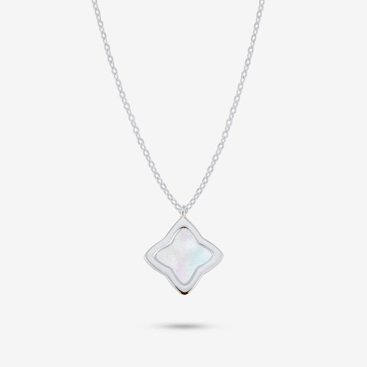 Studio shot of the Silver Creia Necklace with a clover-shaped pendant and mother-of-pearl inlay on a grey background