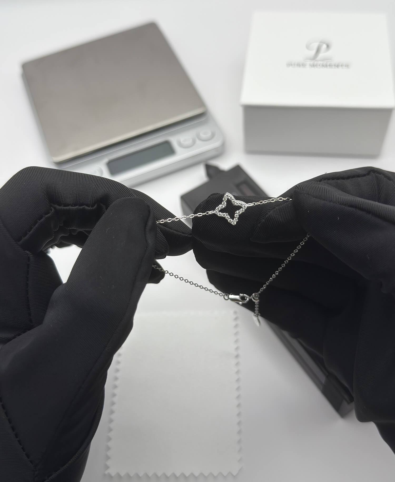A specialist in Singapore performs a meticulous final check on a minimalist sterling silver bracelet, ensuring its quality and finish are perfect before shipping.