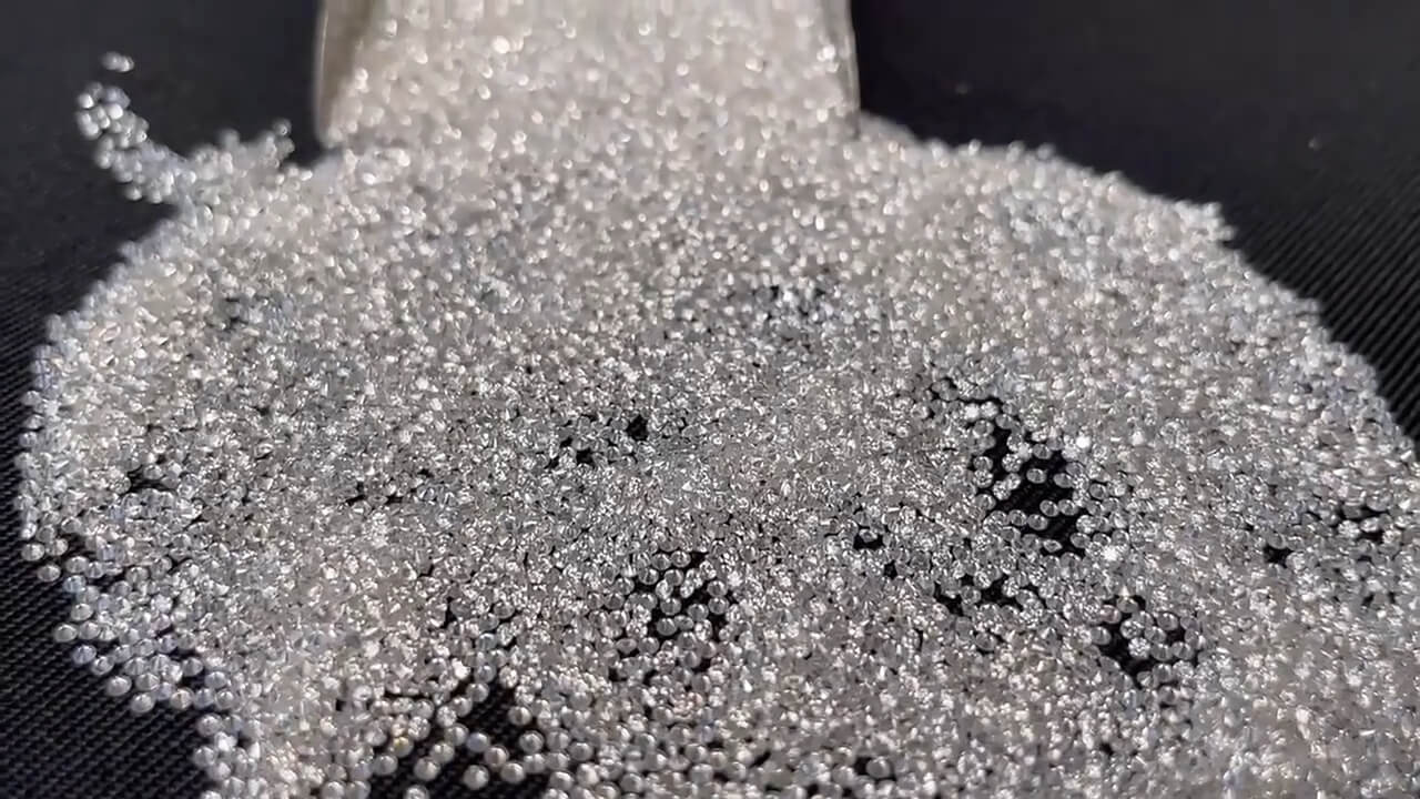 A glittering pile of high-quality cubic zirconia stones, showcasing the brilliant diamond-like sparkle we select for our demi-fine jewellery.